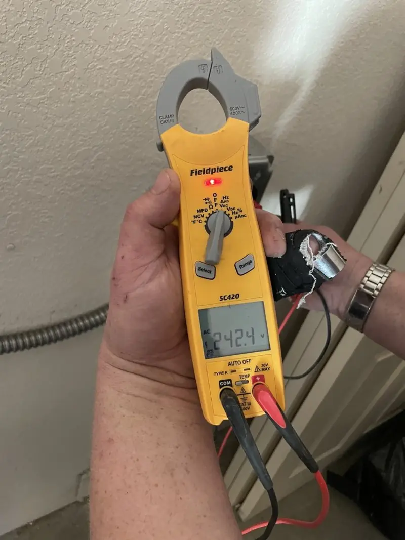 Voltage testing with clamp meter during Ceiling Fan Installation in DeKalb